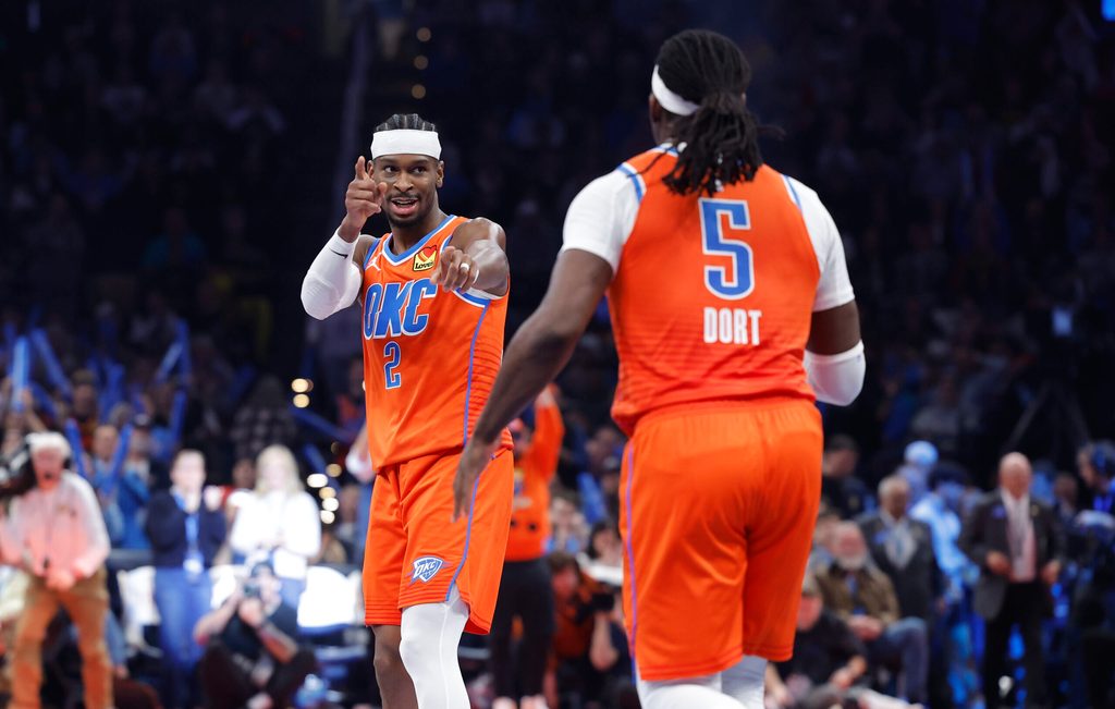 Nov 28, 2025; Oklahoma City, Oklahoma, USA; Oklahoma City Thunder guard Shai Gilgeous-Alexander (2) gestures towards guard Luguentz Dort (5) after a basket against the Phoenix Suns during the second half at Paycom Center. Mandatory Credit: Alonzo Adams-Imagn Images