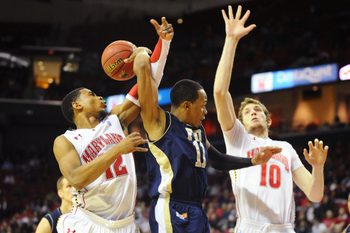 Dec 14, 2011; College Park, MD, USA; FIU Panthers guard Phil Taylor (11) throws a behind the back pass to forward Gilles Dierickx (back) as Maryland Terrapins guard Terrell Stoglin (12) and forward Berend Weijs (10) defend in the second half at Comcast Center. Maryland defeated FIU 65-61.  Mandatory Credit: James Lang-Imagn Images