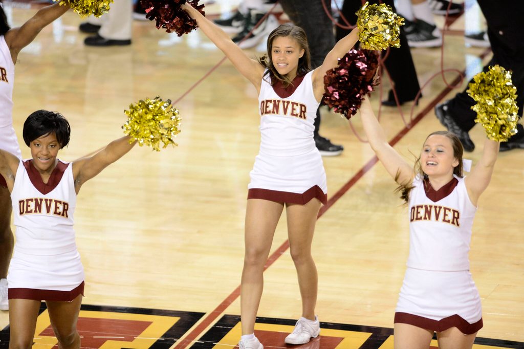 Nov 21, 2012; Denver, CO, USA; Denver Pioneers cheerleaders perform following the game against the Colorado State Rams at Magness Arena. The Rams defeated the Pioneers 60-53. Mandatory Credit: Ron Chenoy-Imagn Images