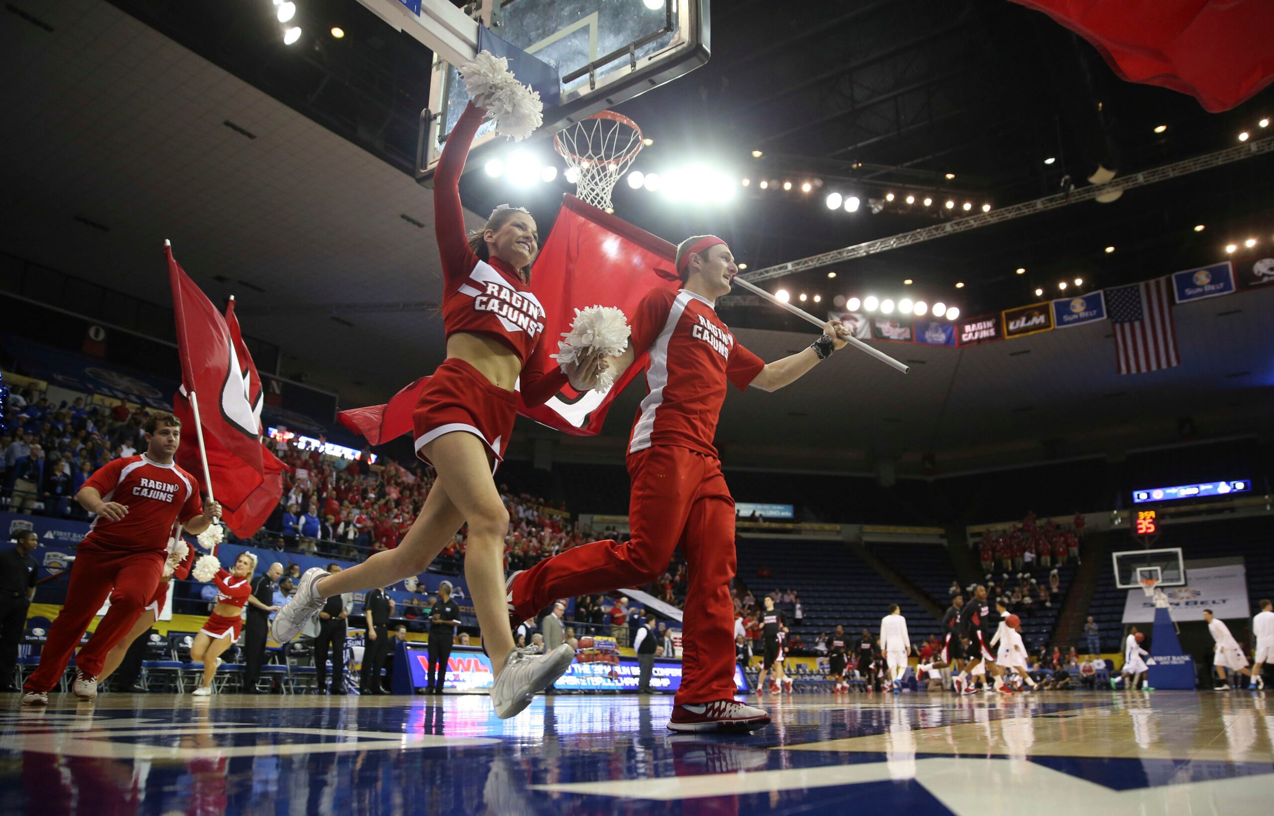 Mar 16, 2014; New Orleans, LA, USA; Louisiana Lafayette Ragin Cajuns cheerleaders lead the team onto the court prior to tipoff against the Georgia State Panthers in the championship game of the Sun Belt Conference college basketball tournament at Lakefront Arena. Louisiana Lafayette defeated Georgia State 82-81. Mandatory Credit: Crystal LoGiudice-Imagn Images