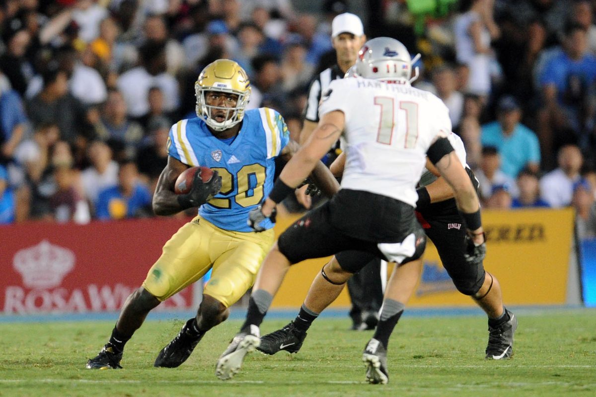 September 10, 2016; Pasadena, CA, USA; UCLA Bruins running back Brandon Stephens (20) runs the ball against the UNLV Rebels during the second half at Rose Bowl. Mandatory Credit: Gary A. Vasquez-Imagn Images