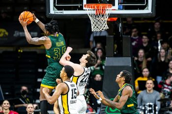 Southeastern Louisiana's Gus Okafor (35) pulls down a rebound against Iowa forwards Keegan Murray (15) and Patrick McCaffery (22) during a NCAA non-conference men's basketball game, Tuesday, Dec. 21, 2021, at Carver-Hawkeye Arena in Iowa City, Iowa.

211221 Se Louisiana Iowa Mbb 016 Jpg