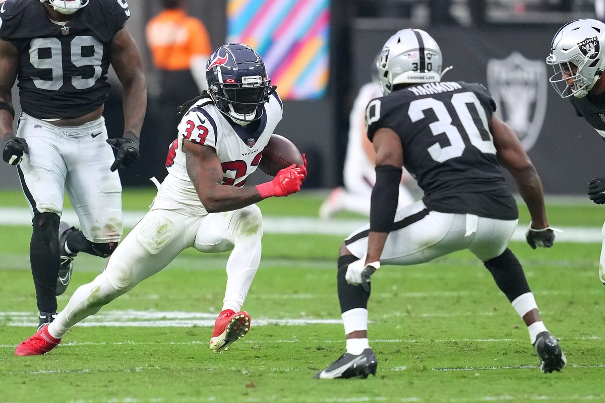 Oct 23, 2022; Paradise, Nevada, USA; Houston Texans running back Dare Ogunbowale (33) rushes towards Las Vegas Raiders safety Duron Harmon (30) during the second half at Allegiant Stadium. Mandatory Credit: Stephen R. Sylvanie-Imagn Images