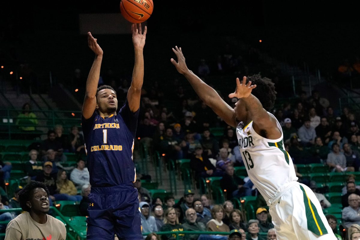 Nov 14, 2022; Waco, Texas, USA; Northern Colorado Bears guard Daylen Kountz (1) shoots against Baylor Bears guard Langston Love (13) during the first half at Ferrell Center. Mandatory Credit: Chris Jones-Imagn Images