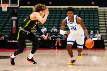 Nov 27, 2022; Orlando, FL, USA; Seton Hall Pirates guard Jaquan Sanders (20) drives the ball up the court against Siena Saints guard Michael Eley (3) during the first half at ESPN Wide World of Sports. Mandatory Credit: Rich Storry-Imagn Images