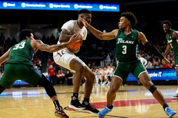 Cincinnati Bearcats guard Landers Nolley II (2) defends the ball against Tulane Green Wave forward Tylan Pope (33) and Tulane Green Wave guard Jalen Cook (3) during the first half of an NCAA men   s college basketball game on Thursday, Dec. 29, 2022, at Fifth Third Arena in Cincinnati. The Bearcats defeated the Green Wave 88-77 with a crowd of 9,484.

Tulane Green Wave At Cincinnati Bearcats Ncaa Basketball Dec 29