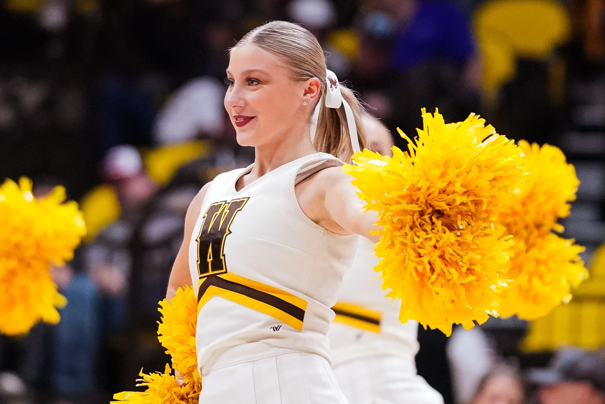 Jan 31, 2023; Laramie, Wyoming, USA; A Wyoming Cowboys cheerleader performs against the Fresno State Bulldogs during the second half at Arena-Auditorium. Mandatory Credit: Troy Babbitt-Imagn Images