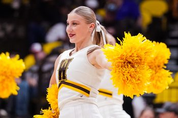 Jan 31, 2023; Laramie, Wyoming, USA; A Wyoming Cowboys cheerleader performs against the Fresno State Bulldogs during the second half at Arena-Auditorium. Mandatory Credit: Troy Babbitt-Imagn Images