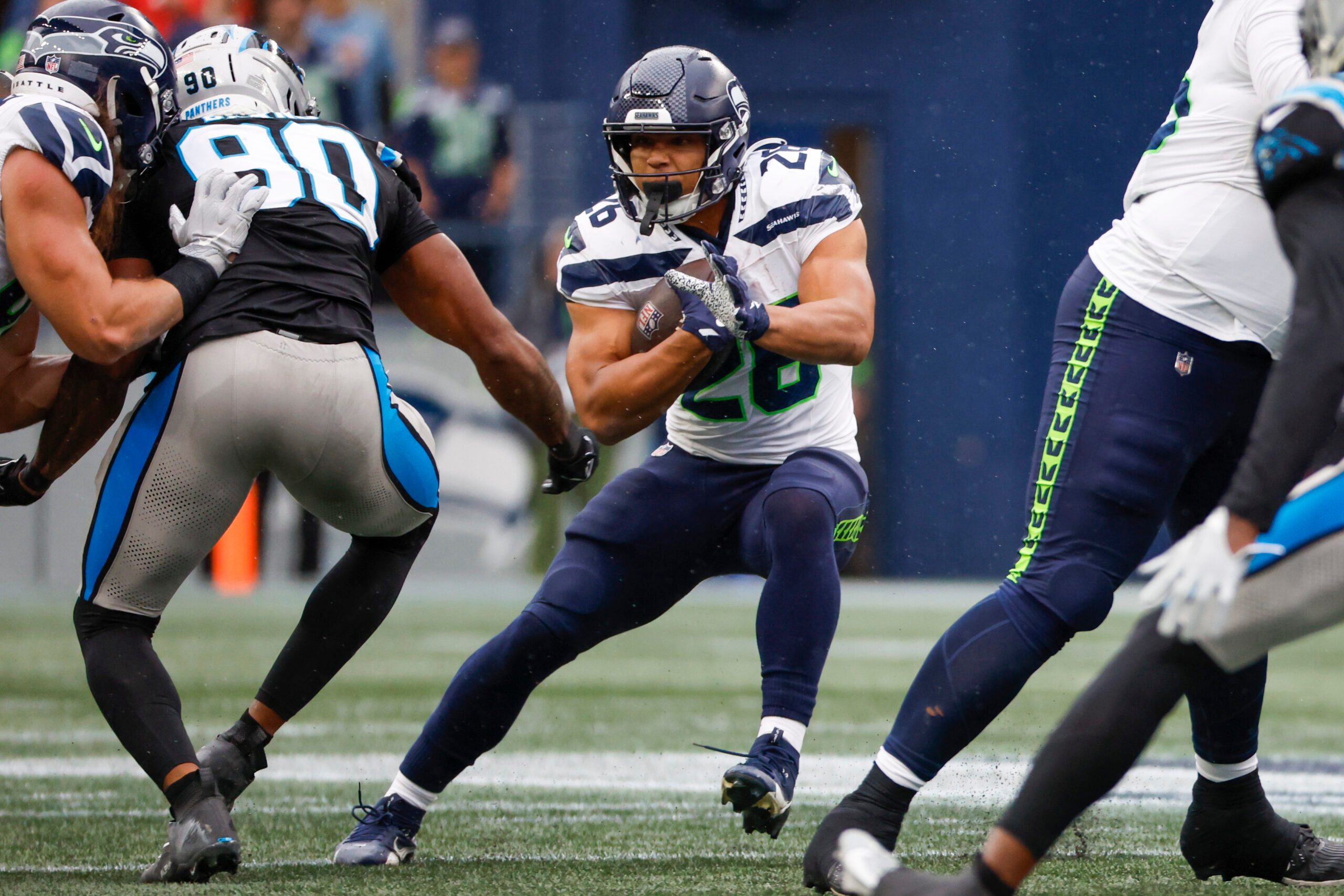 Sep 24, 2023; Seattle, Washington, USA; Seattle Seahawks running back Zach Charbonnet (26) rushes against the Carolina Panthers during the fourth quarter at Lumen Field. Mandatory Credit: Joe Nicholson-Imagn Images