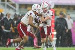 Dec 16, 2023; Orlando, FL, USA;  Miami (OH) Redhawks quarterback Henry Hesson (12) hands off to running back Rashad Amos (0) against the Appalachian State Mountaineers in the first quarter during the Avocados from Mexico Cure Bowl at FBC Mortgage Stadium. Mandatory Credit: Nathan Ray Seebeck-Imagn Images