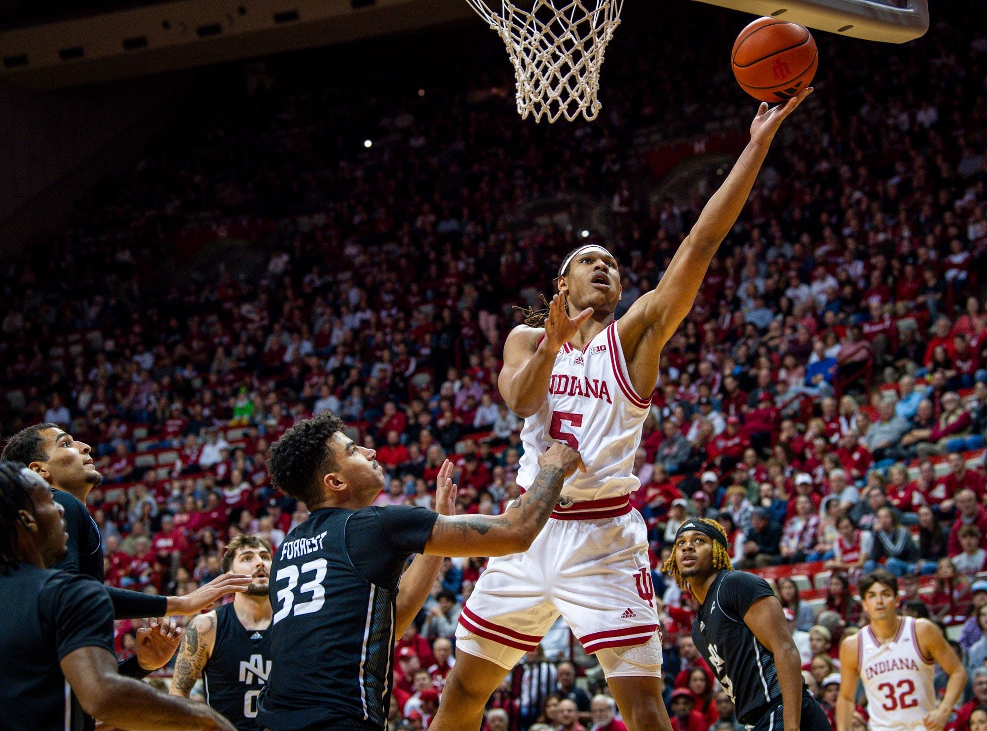 Indiana's Malik Reneau (5) shoots past North Alabama's Damian Forrest (33) during the first half of the Indiana versus North Alabama men's basketball game at Simon Skjodt Assembly Hall on Thursday, December 21, 2023.