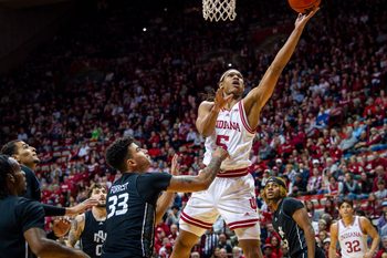 Indiana's Malik Reneau (5) shoots past North Alabama's Damian Forrest (33) during the first half of the Indiana versus North Alabama men's basketball game at Simon Skjodt Assembly Hall on Thursday, December 21, 2023.