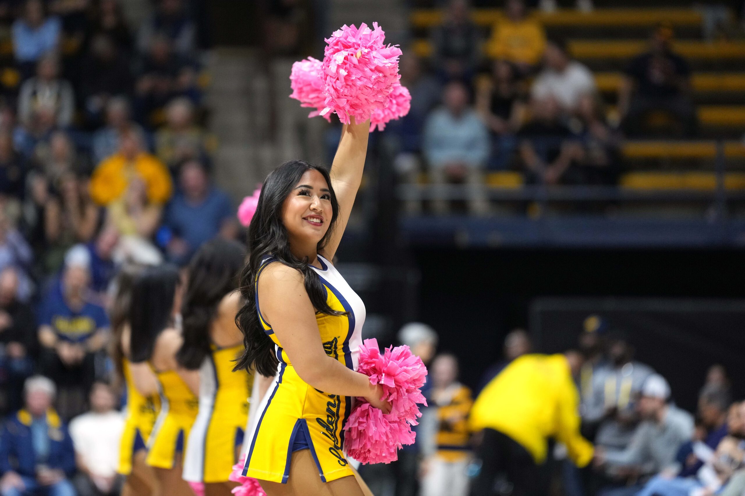 Feb 24, 2024; Berkeley, California, USA; A California Golden Bears cheerleader performs on the court during the first half against the Oregon Ducks at Haas Pavilion. Mandatory Credit: Darren Yamashita-Imagn Images