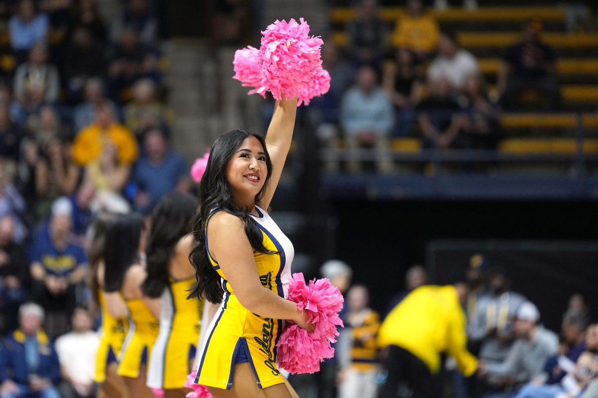 Feb 24, 2024; Berkeley, California, USA; A California Golden Bears cheerleader performs on the court during the first half against the Oregon Ducks at Haas Pavilion. Mandatory Credit: Darren Yamashita-Imagn Images