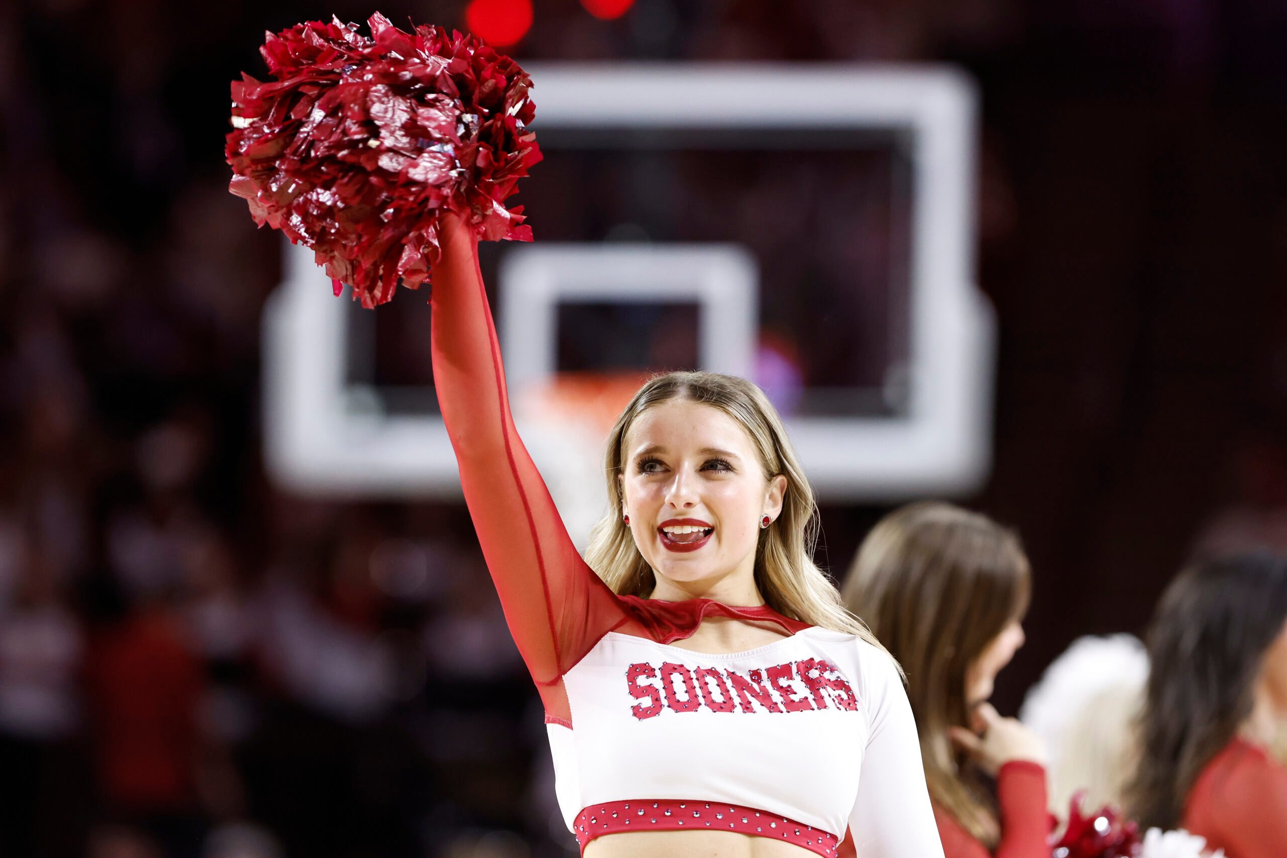 sMar 2, 2024; Norman, Oklahoma, USA; An Oklahoma Sooners Cheerleader performs during a time out against the Houston Cougars during the second half at Lloyd Noble Center. Mandatory Credit: Alonzo Adams-Imagn Images