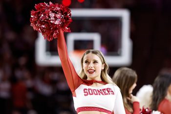 sMar 2, 2024; Norman, Oklahoma, USA; An Oklahoma Sooners Cheerleader performs during a time out against the Houston Cougars during the second half at Lloyd Noble Center. Mandatory Credit: Alonzo Adams-Imagn Images