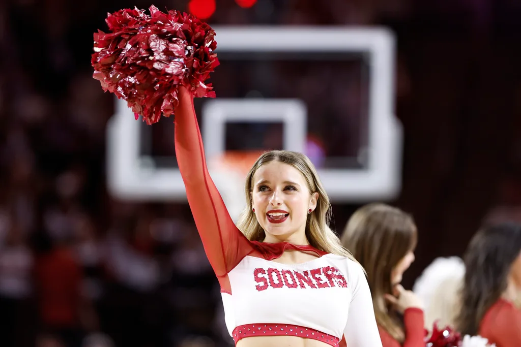 sMar 2, 2024; Norman, Oklahoma, USA; An Oklahoma Sooners Cheerleader performs during a time out against the Houston Cougars during the second half at Lloyd Noble Center. Mandatory Credit: Alonzo Adams-Imagn Images
