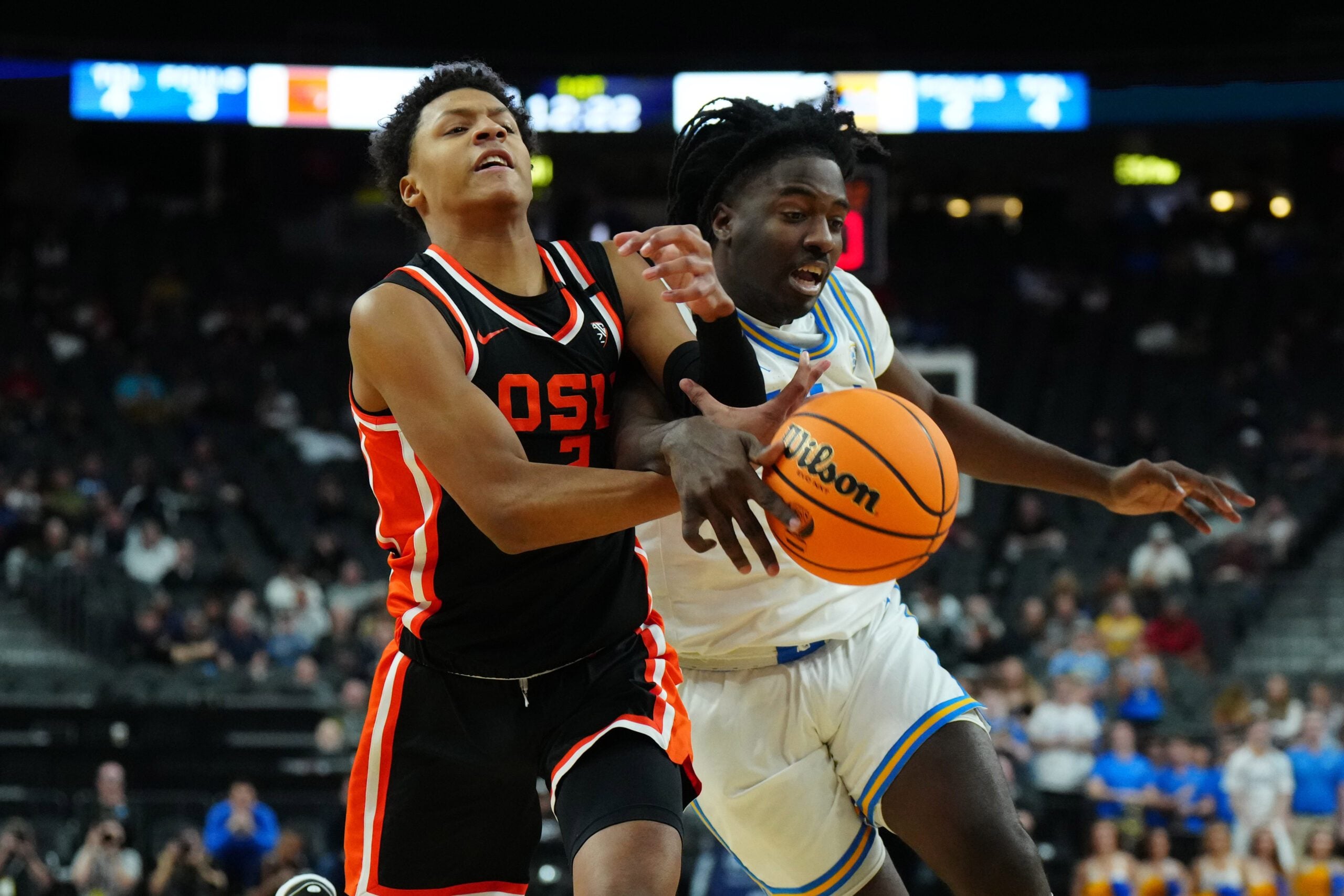 Mar 13, 2024; Las Vegas, NV, USA; Oregon State Beavers guard Josiah Lake II (2) and UCLA Bruins guard Will McClendon (4) battle for the ball in the first half at T-Mobile Arena. Mandatory Credit: Kirby Lee-Imagn Images