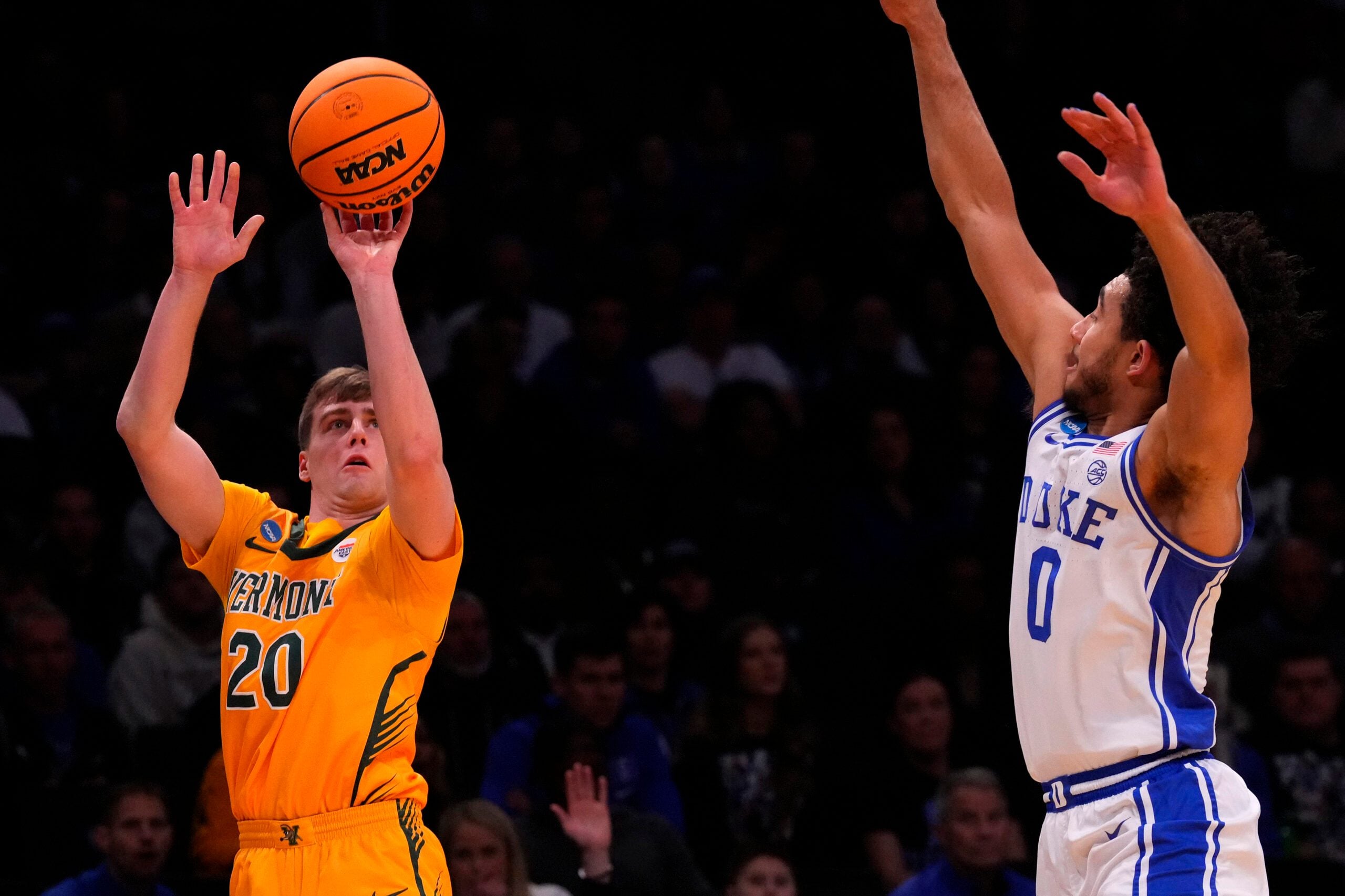 Mar 22, 2024; Brooklyn, NY, USA; Vermont Catamounts guard TJ Long (20) shoots the ball against Duke Blue Devils guard Jared McCain (0) in the first round of the 2024 NCAA Tournament at the Barclays Center. Mandatory Credit: Robert Deutsch-Imagn Images