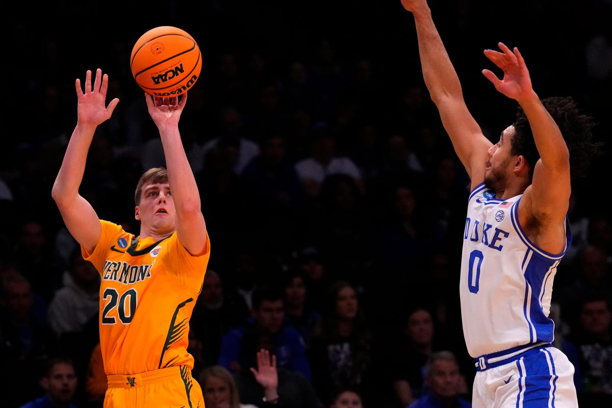 Mar 22, 2024; Brooklyn, NY, USA; Vermont Catamounts guard TJ Long (20) shoots the ball against Duke Blue Devils guard Jared McCain (0) in the first round of the 2024 NCAA Tournament at the Barclays Center. Mandatory Credit: Robert Deutsch-Imagn Images