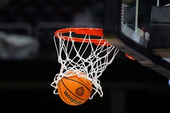 Apr 4, 2024; Cleveland, OH, USA; A Wilson official Evo NXT basketball with the NCAA Women's Final Four March Madness logo approaches the rim and net at Rocket Mortgage FieldHouse. Mandatory Credit: Kirby Lee-Imagn Images