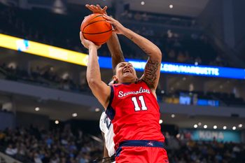 Nov 4, 2024; Milwaukee, Wisconsin, USA;  Stony Brook Seawolves guard-forward Nick Woodard (11) shoots during the first half against the Marquette Golden Eagles at Fiserv Forum. Mandatory Credit: Jeff Hanisch-Imagn Images