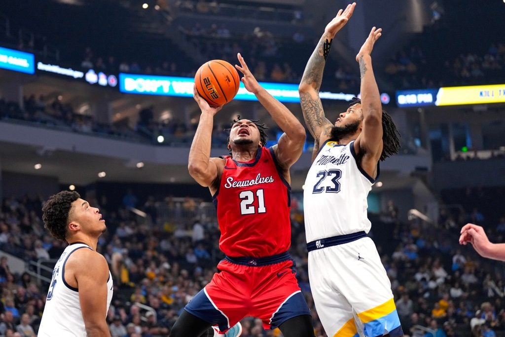 Nov 4, 2024; Milwaukee, Wisconsin, USA; Stony Brook Seawolves guard-forward Andre Snoddy (21) shoots around Marquette Golden Eagles forward David Joplin (23) during the first half at Fiserv Forum. Mandatory Credit: Jeff Hanisch-Imagn Images