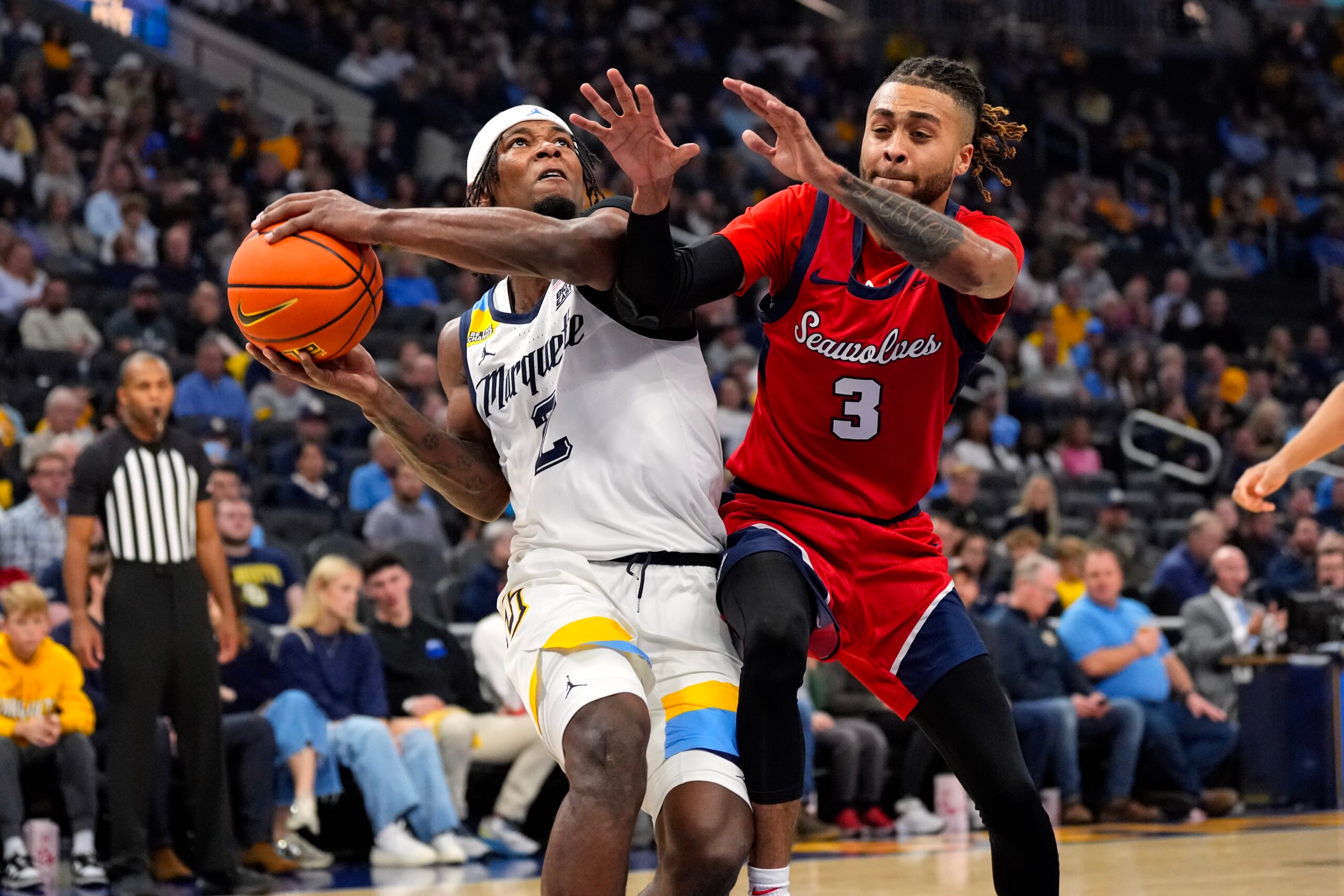 Nov 4, 2024; Milwaukee, Wisconsin, USA;  Marquette Golden Eagles guard Chase Ross (2) drives for the basket against Stony Brook Seawolves guard CJ Luster II (3) during the second half at Fiserv Forum. Mandatory Credit: Jeff Hanisch-Imagn Images