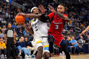 Nov 4, 2024; Milwaukee, Wisconsin, USA;  Marquette Golden Eagles guard Chase Ross (2) drives for the basket against Stony Brook Seawolves guard CJ Luster II (3) during the second half at Fiserv Forum. Mandatory Credit: Jeff Hanisch-Imagn Images