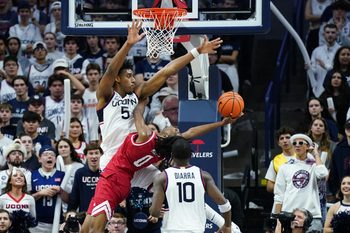 Nov 6, 2024; Storrs, Connecticut, USA; Connecticut Huskies center Tarris Reed Jr. (5) defends against Sacred Heart Pioneers guard Keyishon Miller (0) in the second half at Harry A. Gampel Pavilion. Mandatory Credit: David Butler II-Imagn Images
