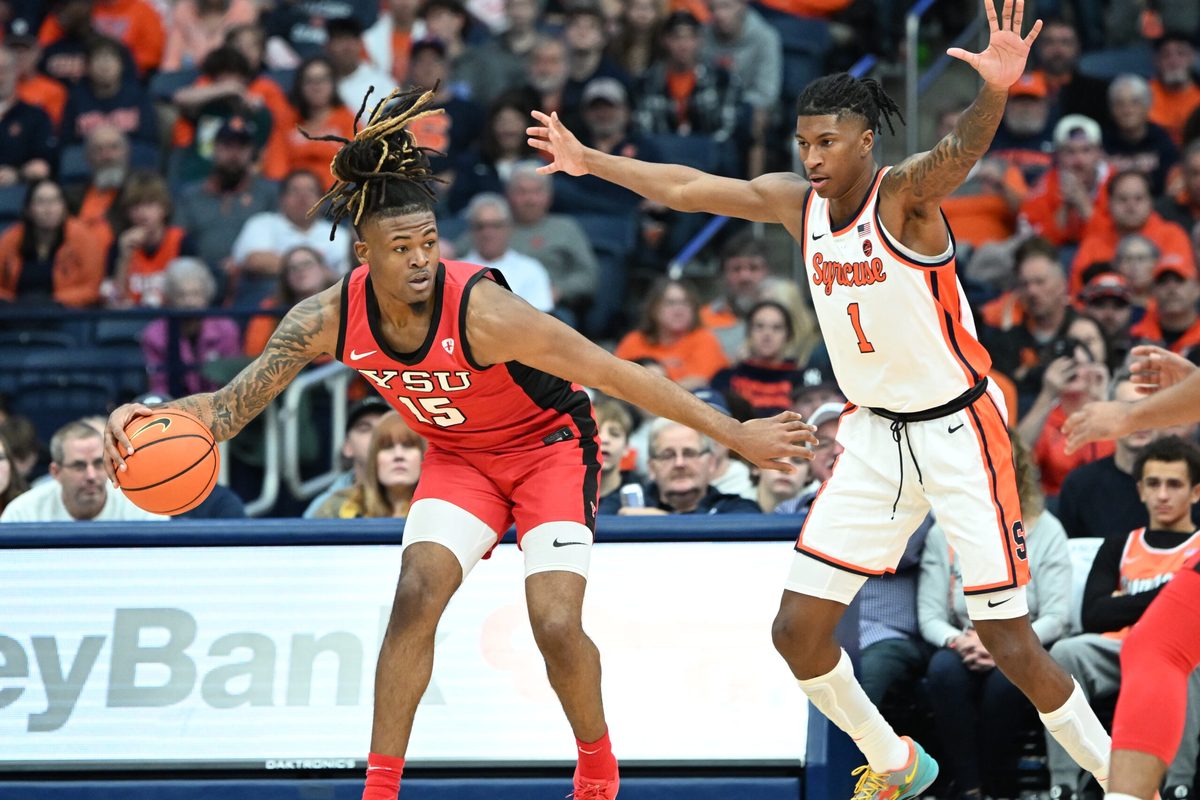 Nov 16, 2024; Syracuse, New York, USA; Youngstown State Penguins forward Cris Carroll (15) tries to move past Syracuse Orange forward Donnie Freeman (1) in the second half at the JMA Wireless Dome. Mandatory Credit: Mark Konezny-Imagn Images