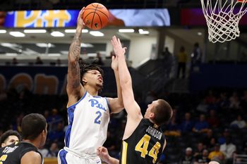 Nov 18, 2024; Pittsburgh, Pennsylvania, USA;  Pittsburgh Panthers forward Cameron Corhen (2) shoots against Virginia Military Keydets forward TJ Johnson (44) during the first half at the Petersen Events Center. Mandatory Credit: Charles LeClaire-Imagn Images