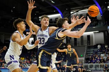 Nov 19, 2024; Evanston, Illinois, USA; Montana State Bobcats guard Patrick McMahon (1) and Northwestern Wildcats forward Luke Hunger (33) go for the ball during the first half at Welsh-Ryan Arena. Mandatory Credit: David Banks-Imagn Images