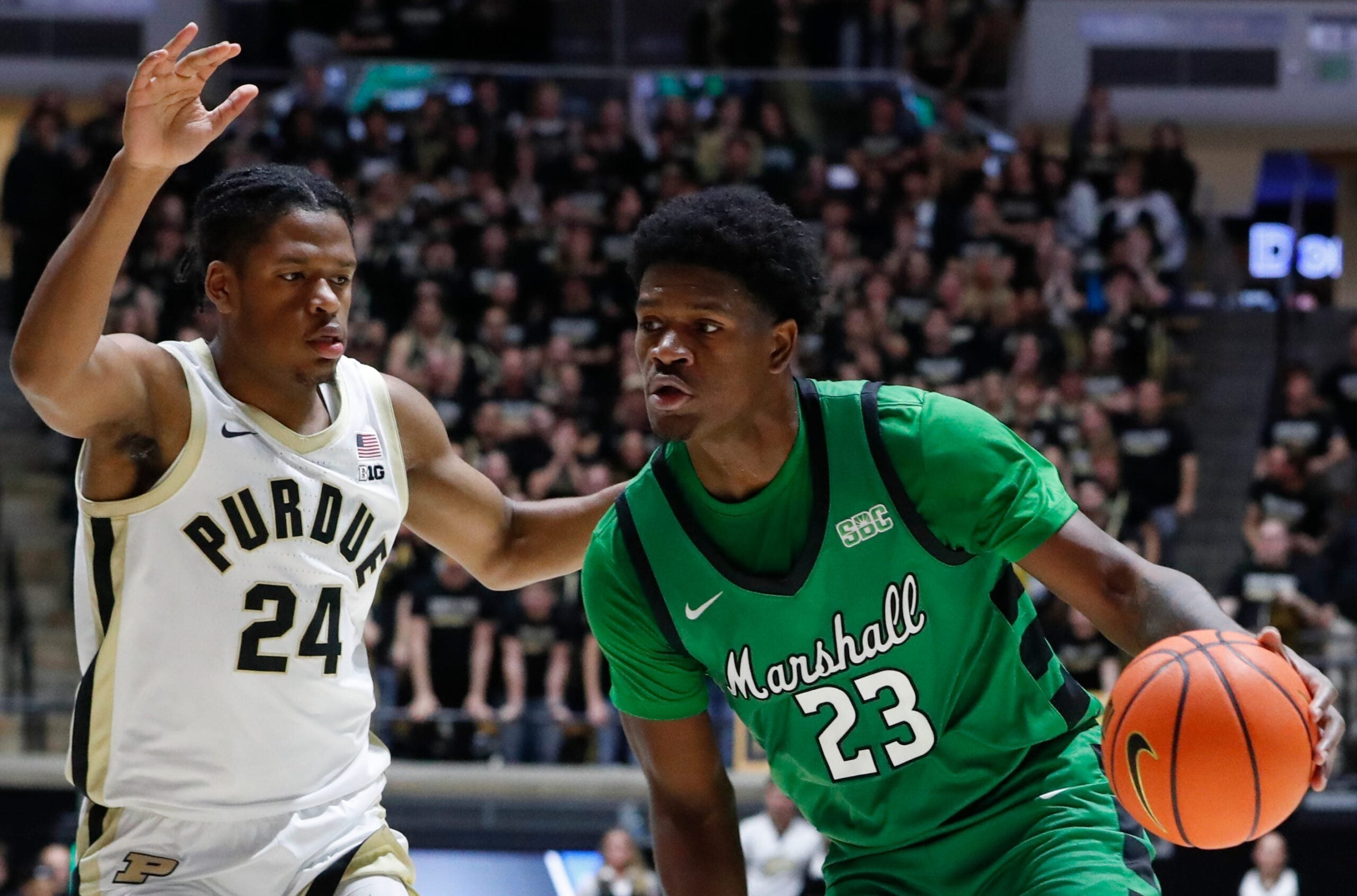 Purdue Boilermakers guard Gicarri Harris (24) defends Marshall Thundering Herd guard Mikal Dawson (23) Saturday, Nov. 23, 2024, during the NCAA men’s basketball game at Mackey Arena in West Lafayette, Ind.