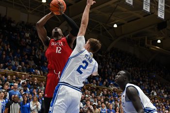 Nov 29, 2024; Durham, North Carolina, USA;Seattle Redhawks forward Matthew-Alexander Moncrieffe (12) shoots over Duke Blue Devils forward Cooper Flagg (2)during the first half at Cameron Indoor Stadium. Mandatory Credit: Rob Kinnan-Imagn Images