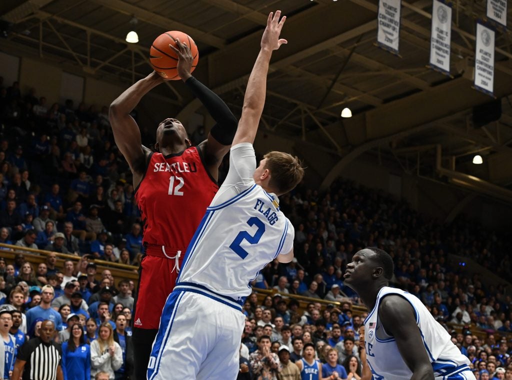 Nov 29, 2024; Durham, North Carolina, USA;Seattle Redhawks forward Matthew-Alexander Moncrieffe (12)
shoots over Duke Blue Devils forward Cooper Flagg (2)during the first half at Cameron Indoor Stadium. Mandatory Credit: Rob Kinnan-Imagn Images