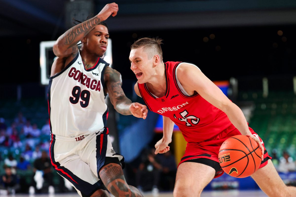 Nov 29, 2024; Paradise Island, Bahamas, BHS;  Davidson Wildcats guard Roberts Blums (45) drives to the basket as Gonzaga Bulldogs guard Khalif Battle (99) defends during the second half at Imperial Arena at the Atlantis resort.  Mandatory Credit: Kevin Jairaj-Imagn Images