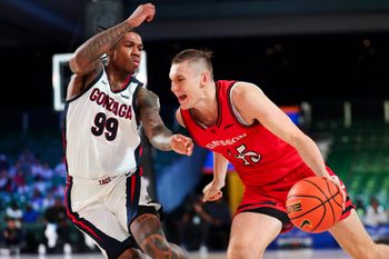 Nov 29, 2024; Paradise Island, Bahamas, BHS;  Davidson Wildcats guard Roberts Blums (45) drives to the basket as Gonzaga Bulldogs guard Khalif Battle (99) defends during the second half at Imperial Arena at the Atlantis resort.  Mandatory Credit: Kevin Jairaj-Imagn Images