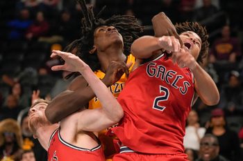 Jaydan Quaintance, 21, of Arizona State University holds down and rebounds the ball against Saint Mary's College defenders Jordan Ross, 2, and Augustas Marciulionis, 3, during the 2024 Acrisure Men's Classic in Palm Desert, Calif., Nov. 29, 2024.