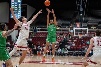 Dec 3, 2024; Stanford, California, USA; Utah Valley Wolverines guard Kylin Green (3) shoots a three point shot agonist Stanford Cardinal forward Maxime Raynaud (42) during the second half at Maples Pavilion. Mandatory Credit: Neville E. Guard-Imagn Images