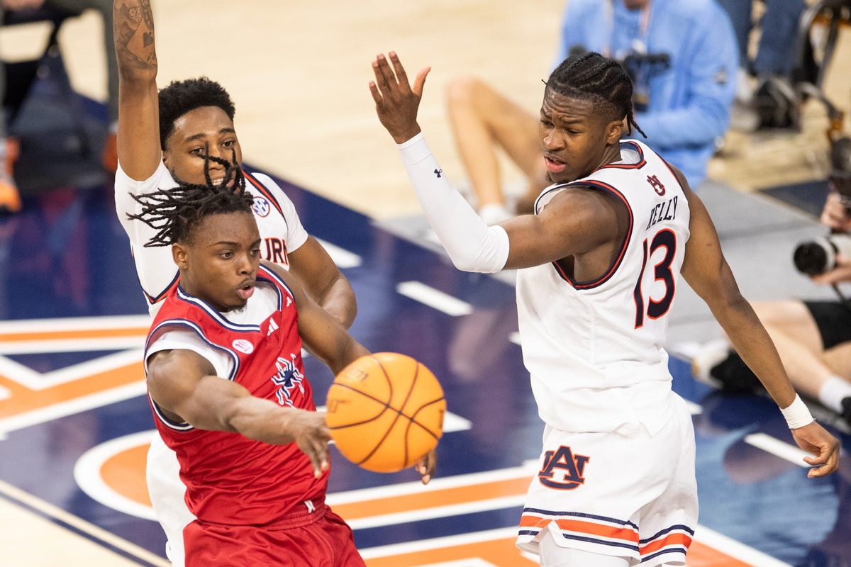 Richmond Spiders guard Mikkel Tyne (1) passes out as Auburn Tigers take on Richmond Spiders at Neville Arena in Auburn, Ala., on Saturday, Dec. 8, 2024. Auburn Tigers defeated Richmond Spiders 98-54.
