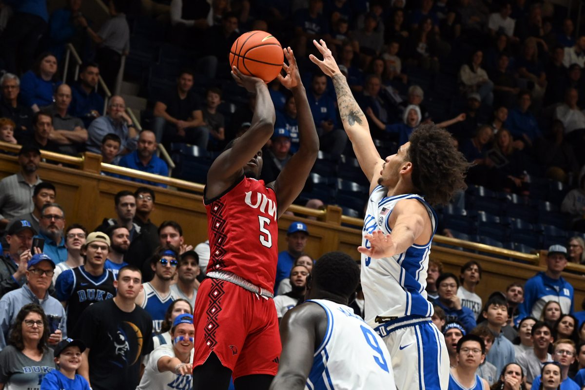 Dec 10, 2024; Durham, North Carolina, USA;  dIncarnate Word Cardinals guard Davion Bailey (5) shoots over Duke Blue Devils guard Tyrese Proctor (5) uring the first half at Cameron Indoor Stadium. Mandatory Credit: Rob Kinnan-Imagn Images