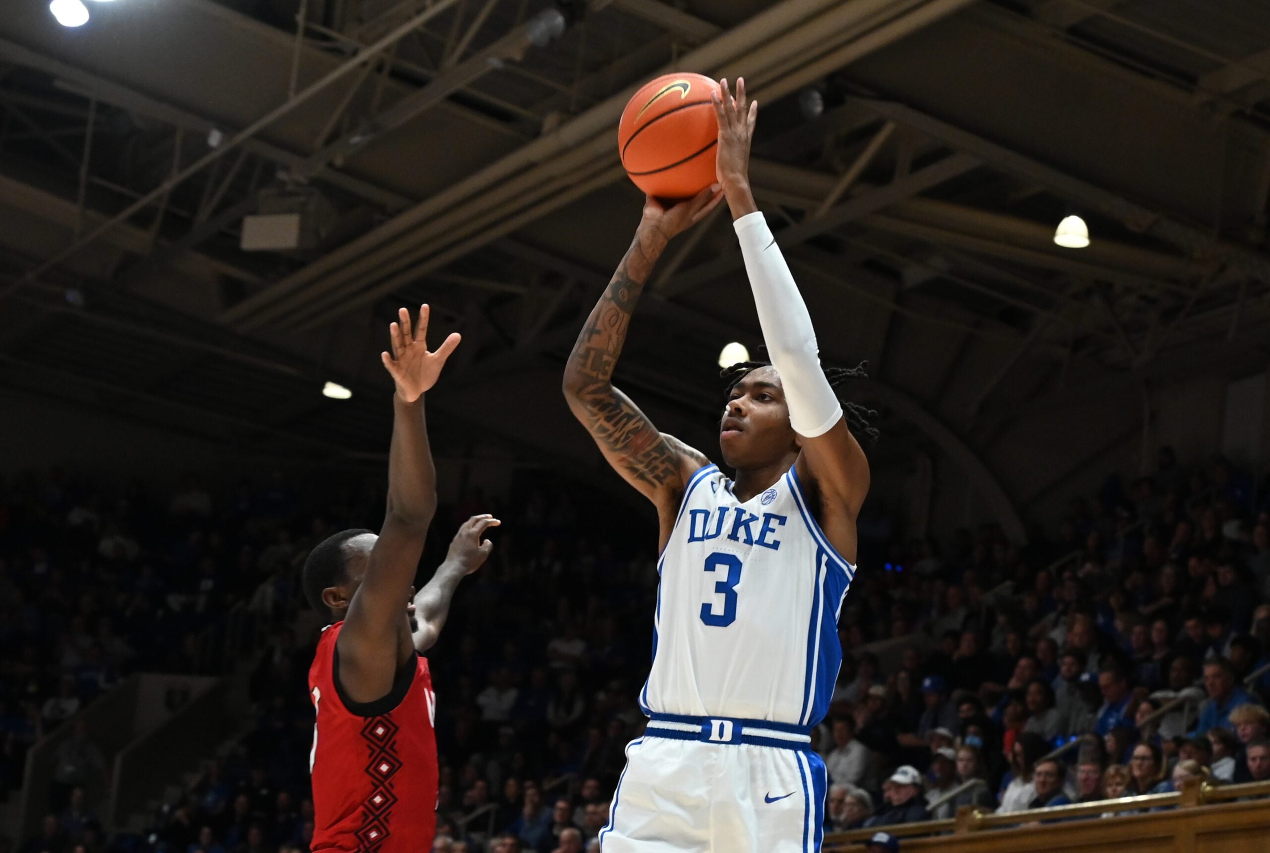 Dec 10, 2024; Durham, North Carolina, USA;  Duke Blue Devils forward Isaiah Evans (3) shoots over Incarnate Word Cardinals guard Davion Bailey (5) during the second half at Cameron Indoor Stadium. Mandatory Credit: Rob Kinnan-Imagn Images
