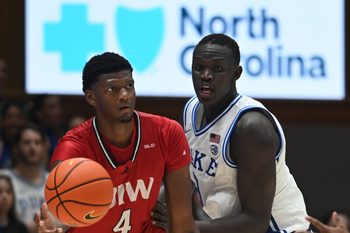 Dec 10, 2024; Durham, North Carolina, USA; Incarnate Word Cardinals forward Jayden Williams (4) looks to pass as Duke Blue Devils center Khaman Maluach (9) defends  during the second half at Cameron Indoor Stadium. Mandatory Credit: Rob Kinnan-Imagn Images
