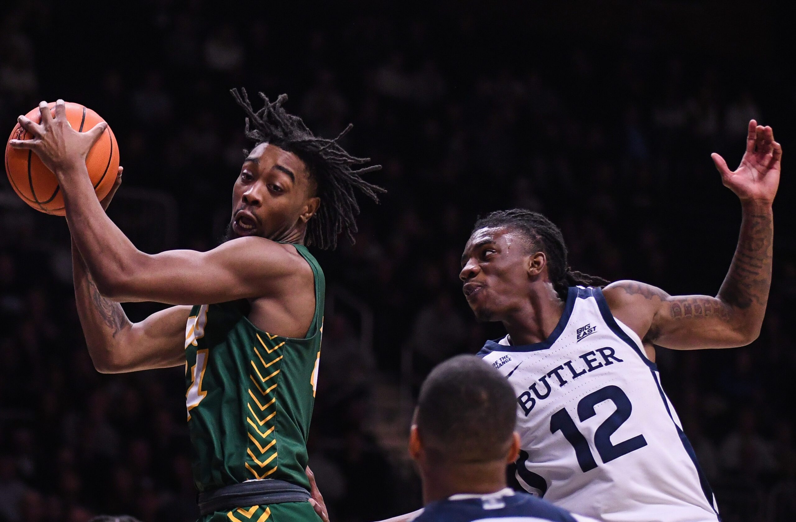 Dec 10, 2024; Indianapolis, Indiana, USA; North Dakota State Bison guard Tajavis Miller (21) rebounds the ball against Butler Bulldogs guard Kolby King (12) during the second half at Hinkle Fieldhouse. Mandatory Credit: Robert Goddin-Imagn Images