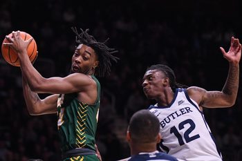 Dec 10, 2024; Indianapolis, Indiana, USA; North Dakota State Bison guard Tajavis Miller (21) rebounds the ball against Butler Bulldogs guard Kolby King (12) during the second half at Hinkle Fieldhouse. Mandatory Credit: Robert Goddin-Imagn Images