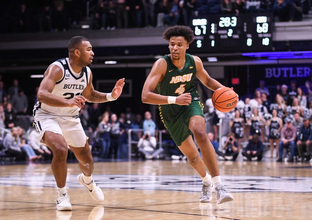Dec 10, 2024; Indianapolis, Indiana, USA; North Dakota State Bison forward Jacksen Moni (4) drives to the basket against Butler Bulldogs forward Pierre Brooks II (21) during the second half at Hinkle Fieldhouse. Mandatory Credit: Robert Goddin-Imagn Images