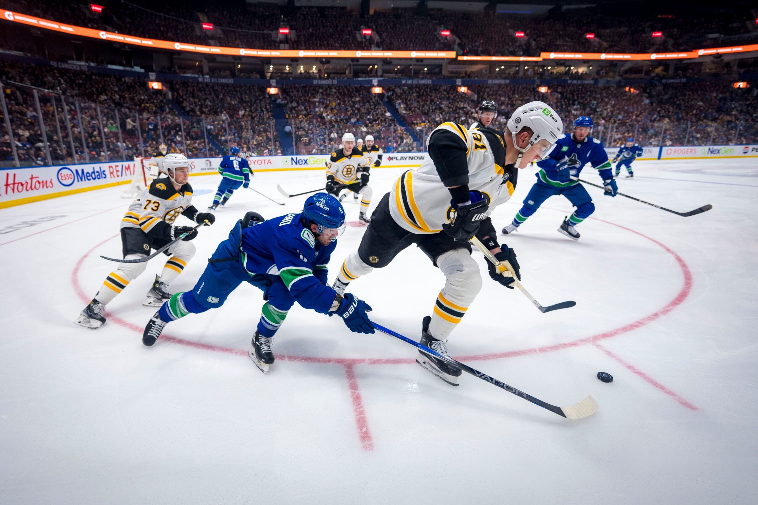 Dec 14, 2024; Vancouver, British Columbia, CAN; Boston Bruins defenseman Charlie McAvoy (73) watches as Vancouver Canucks forward Conor Garland (8) stick checks  defenseman Nikita Zadorov (91) during the second period at Rogers Arena. Mandatory Credit: Bob Frid-Imagn Images
