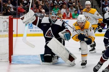 Dec 14, 2024; Denver, Colorado, USA; Colorado Avalanche goaltender Mackenzie Blackwood (39) gets tripped up by Nashville Predators right wing Luke Evangelista (77) in the third period at Ball Arena. Mandatory Credit: Isaiah J. Downing-Imagn Images