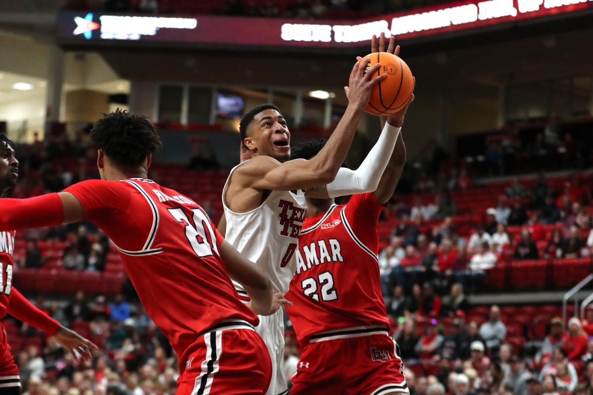 Dec 21, 2024; Lubbock, Texas, USA; Texas Tech Red Raiders guard Chance McMillian (0) reacts going to the basket against Lamar Cardinals forward Andrew Holifield (22) in the first half at United Supermarkets Arena. Mandatory Credit: Michael C. Johnson-Imagn Images